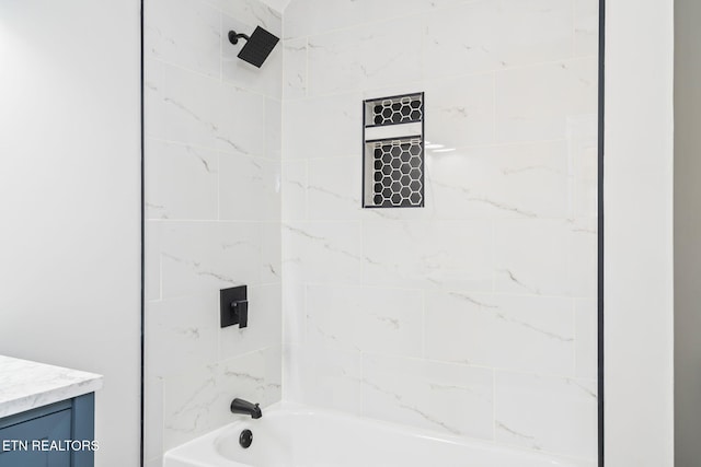 bathroom featuring vanity and tiled shower / bath combo