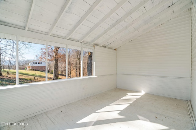 unfurnished sunroom featuring vaulted ceiling with beams and wood ceiling