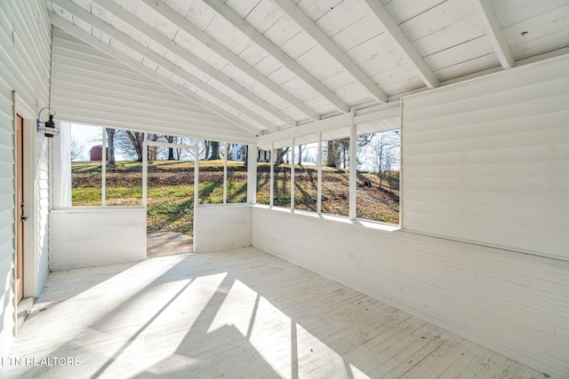 unfurnished sunroom featuring vaulted ceiling with beams and wood ceiling