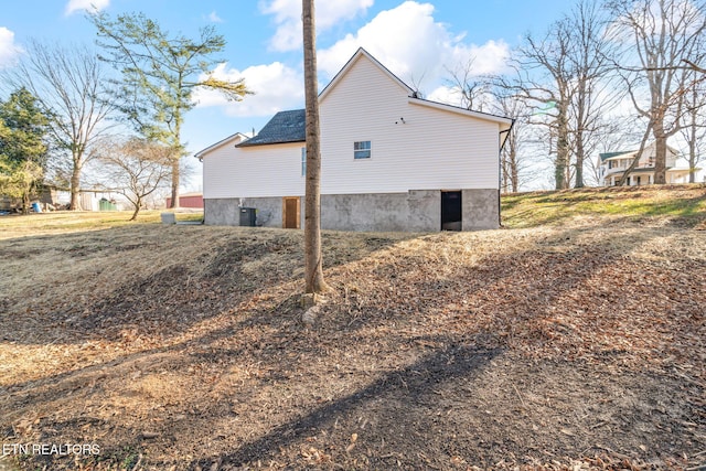 view of side of home featuring central AC