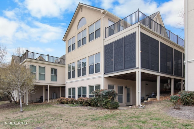 back of house featuring stucco siding