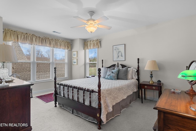 carpeted bedroom with ceiling fan, visible vents, and baseboards