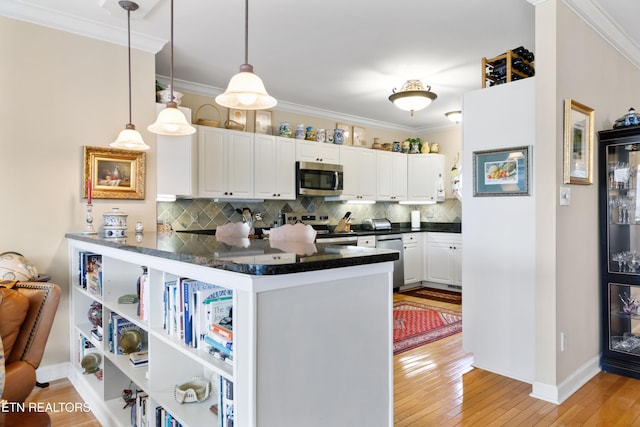 kitchen with stainless steel appliances, white cabinets, ornamental molding, light wood-type flooring, and backsplash