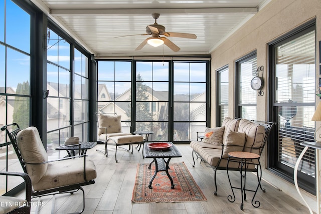 sunroom featuring ceiling fan