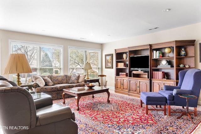 living area with visible vents and baseboards