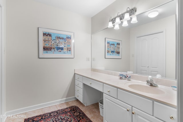 bathroom with tile patterned flooring, vanity, and baseboards