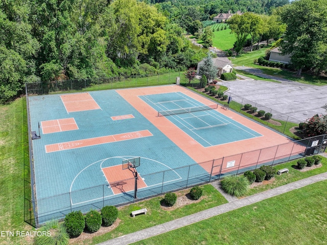 view of sport court featuring a lawn and fence