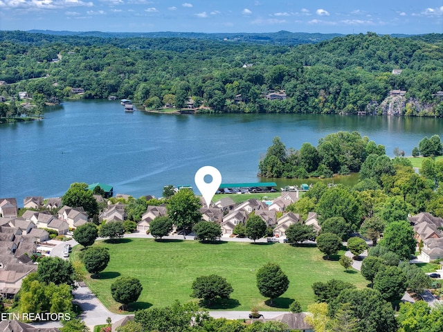 birds eye view of property with a water view, a residential view, and a view of trees