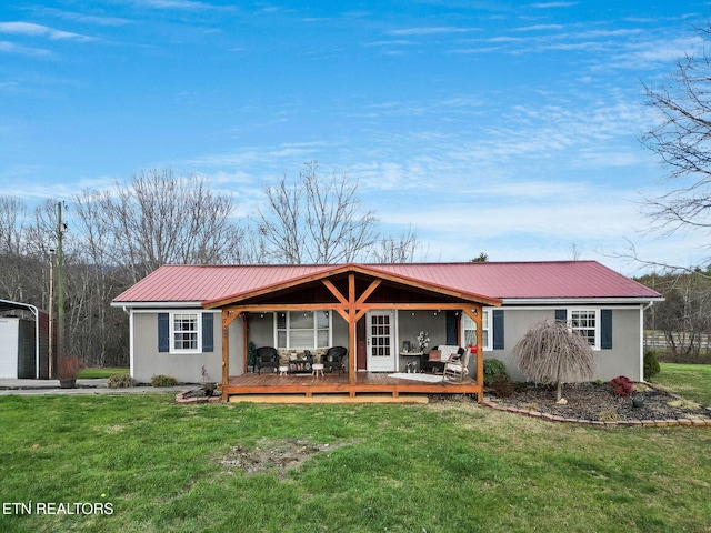 ranch-style house featuring a deck and a front lawn