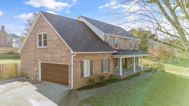 view of home's exterior featuring a porch, a yard, and a garage