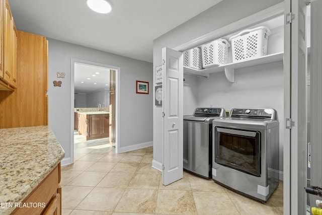 laundry area with sink, separate washer and dryer, and light tile patterned flooring