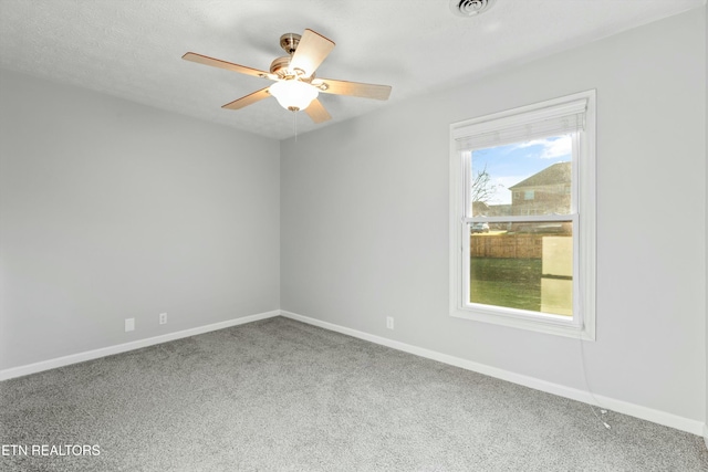 empty room featuring ceiling fan and carpet floors