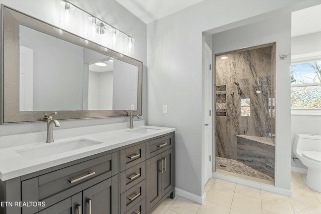 bathroom featuring tile patterned floors, toilet, vanity, and tiled shower