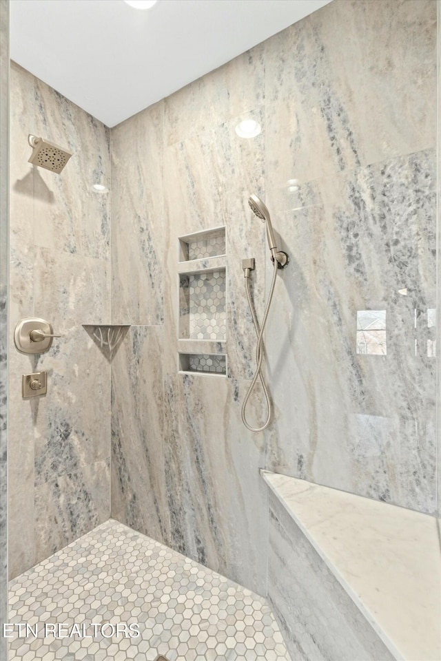 bathroom featuring tiled shower