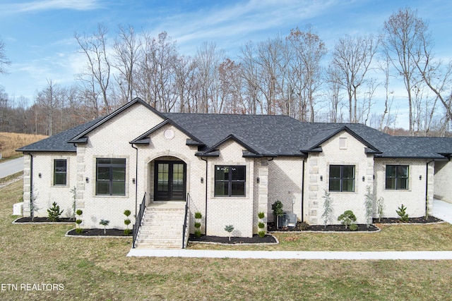 view of front facade with french doors and a front yard