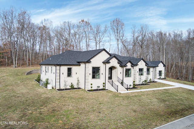 french country style house with a front lawn