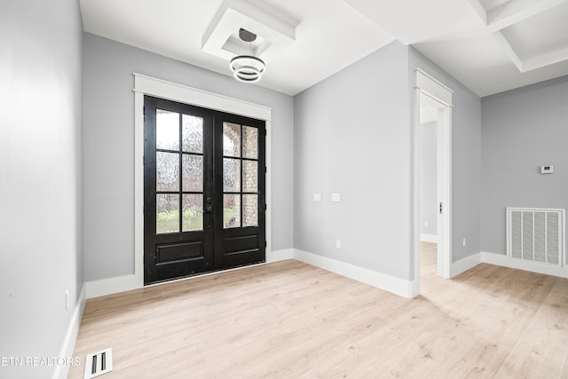 entrance foyer featuring french doors, light hardwood / wood-style floors, and coffered ceiling