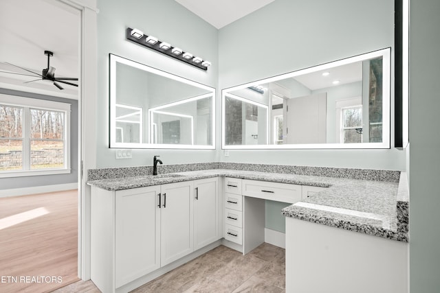 bathroom with ceiling fan and vanity