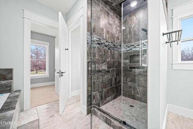 bathroom with tile patterned flooring and a shower with door