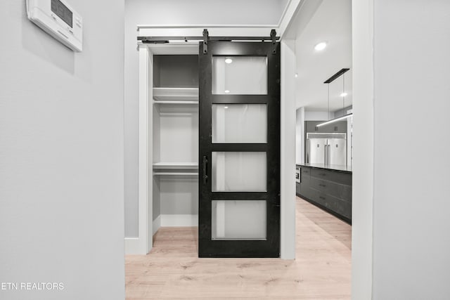 interior space featuring a barn door and light hardwood / wood-style flooring