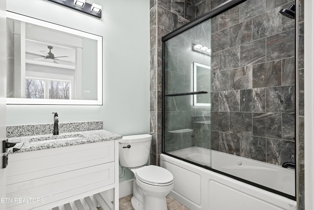 full bathroom featuring vanity, toilet, ceiling fan, and bath / shower combo with glass door