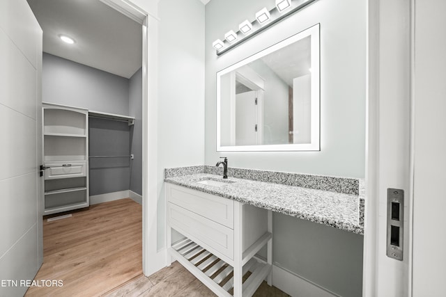 bathroom featuring hardwood / wood-style floors and vanity