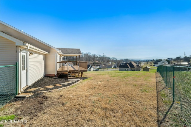 view of yard with a shed and a wooden deck