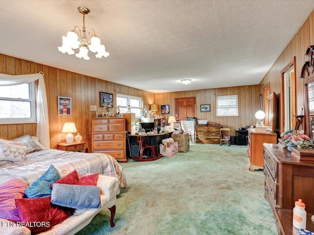 bedroom featuring multiple windows, a chandelier, light colored carpet, and a textured ceiling