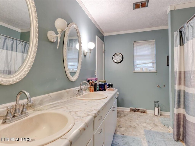 bathroom with vanity, a textured ceiling, and crown molding