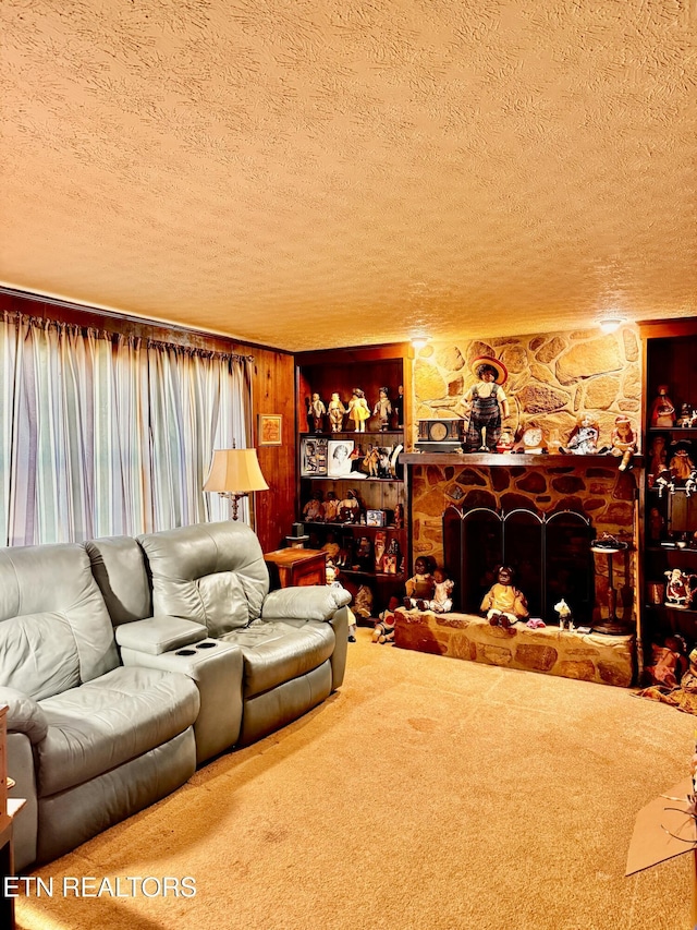 carpeted living room with a textured ceiling and a stone fireplace