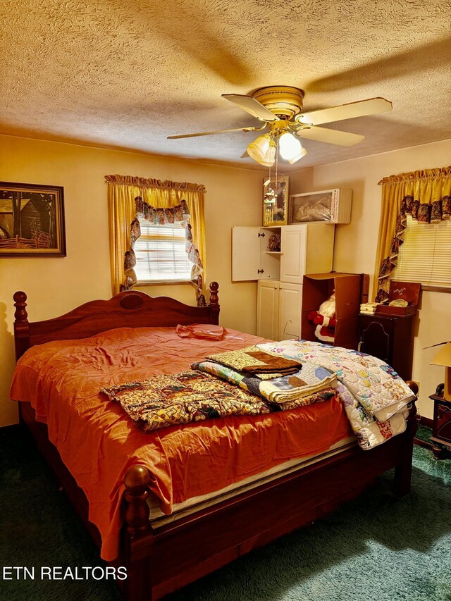 carpeted bedroom with a textured ceiling and ceiling fan