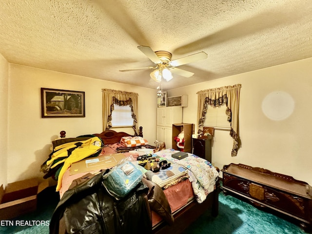 carpeted bedroom featuring a textured ceiling and ceiling fan