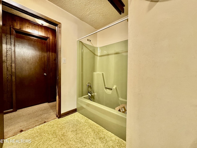 bathroom featuring a textured ceiling and washtub / shower combination