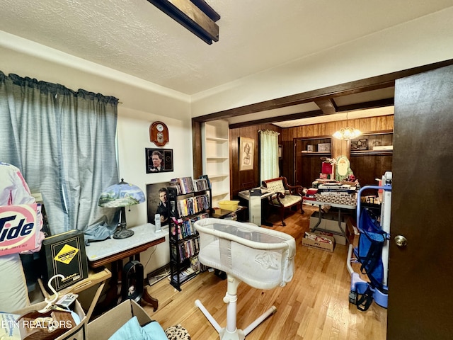 office area with light hardwood / wood-style floors and a textured ceiling