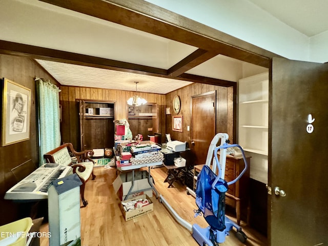 misc room featuring wood-type flooring, beam ceiling, and wooden walls