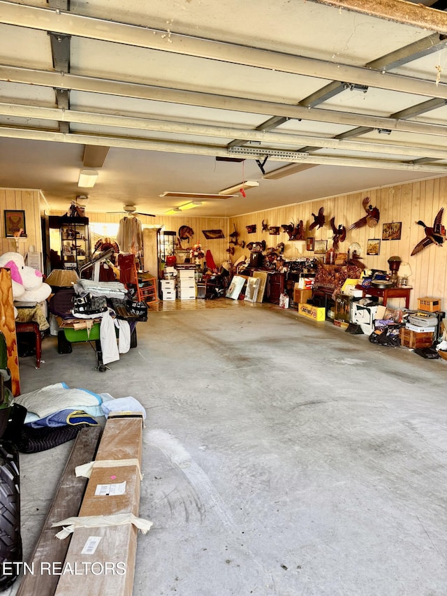 garage with a workshop area and wooden walls