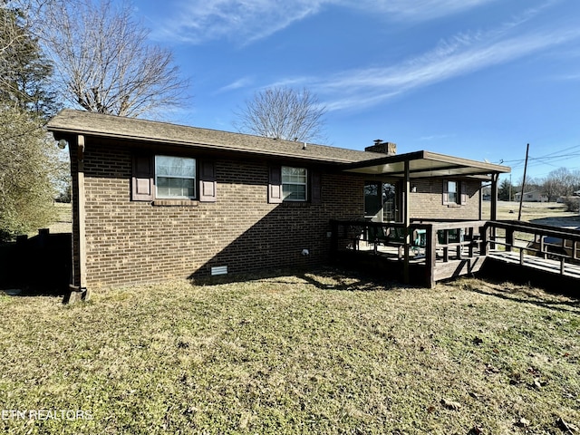 rear view of property featuring a yard