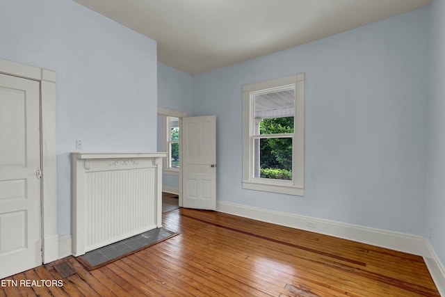 spare room with wood-type flooring