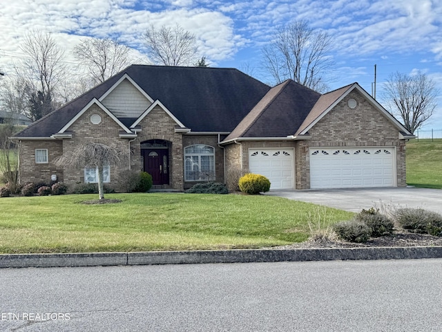 view of front of house featuring a front yard and a garage