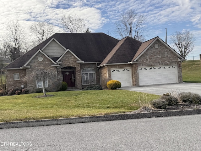 view of front of house with a garage and a front yard