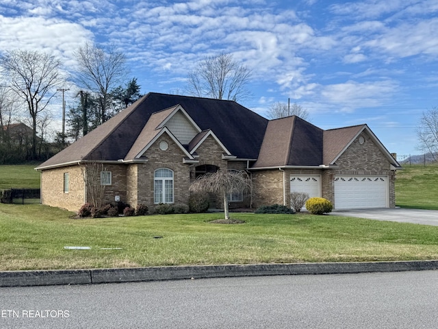 view of front of house featuring a garage and a front lawn