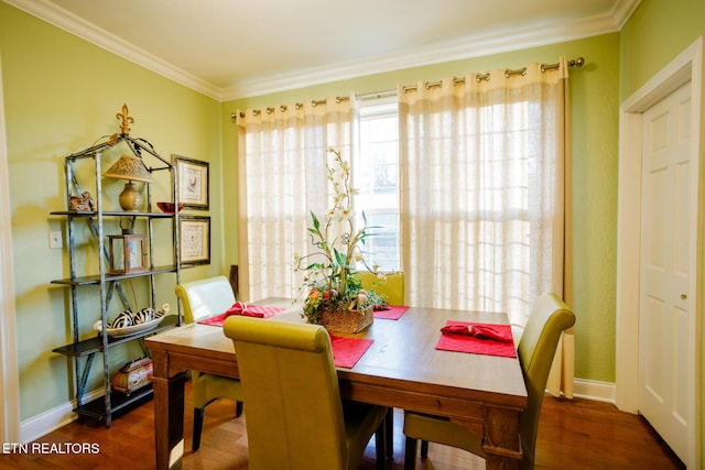 dining area with crown molding and dark hardwood / wood-style floors