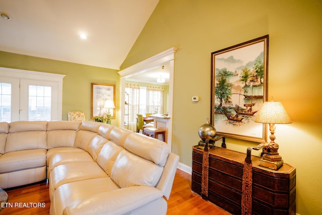 living room with hardwood / wood-style flooring and lofted ceiling