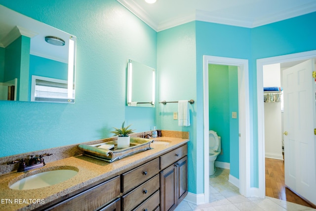 bathroom featuring crown molding, vanity, toilet, and tile patterned flooring