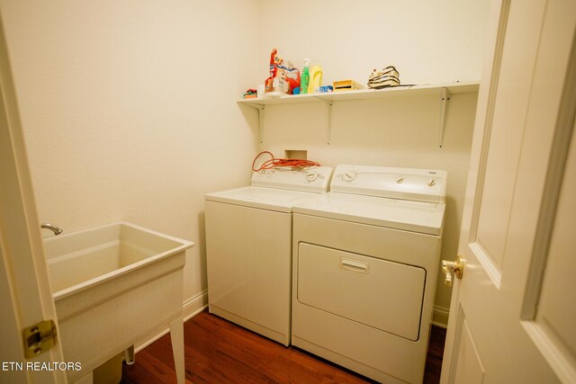 laundry area with separate washer and dryer, dark hardwood / wood-style floors, and sink