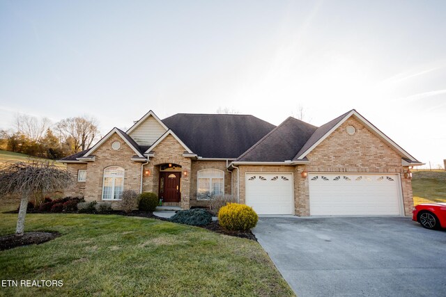 view of front of property featuring a garage and a front lawn