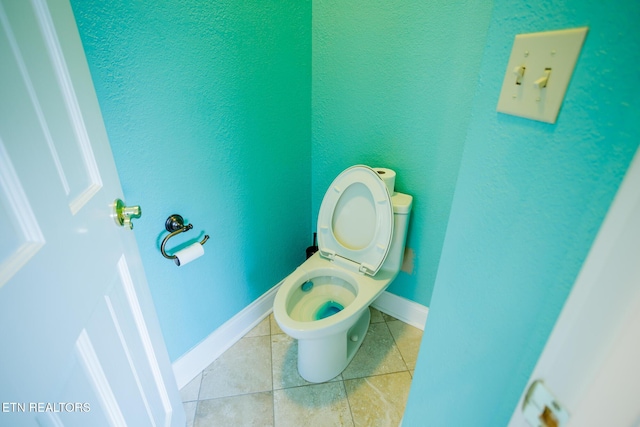 bathroom with tile patterned floors and toilet