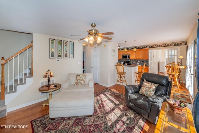 living room with hardwood / wood-style flooring and ceiling fan