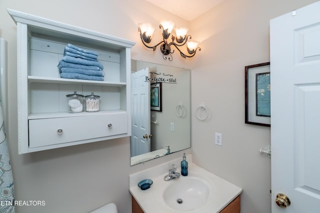 bathroom with vanity and a notable chandelier