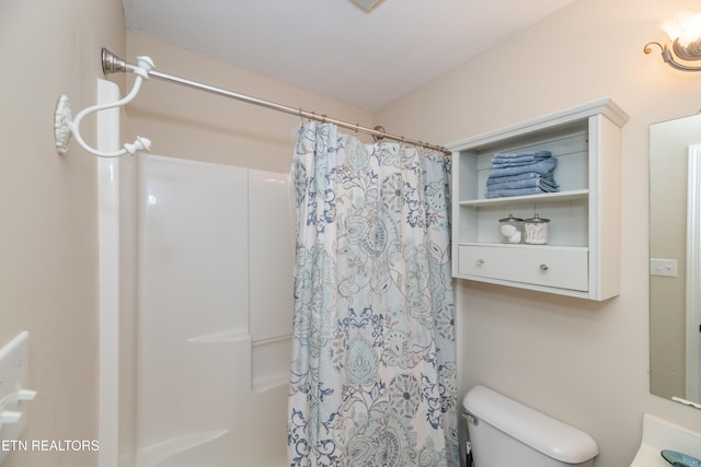 bathroom with toilet and curtained shower